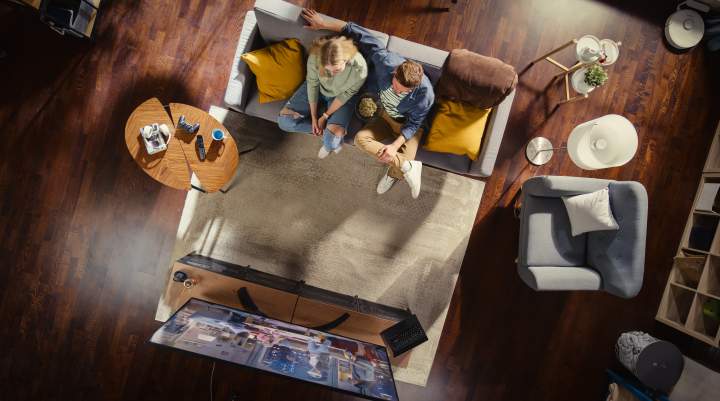 Couple sitting on the couch watching TV