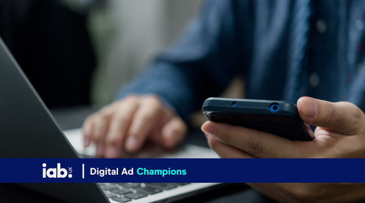 person on phone and laptop