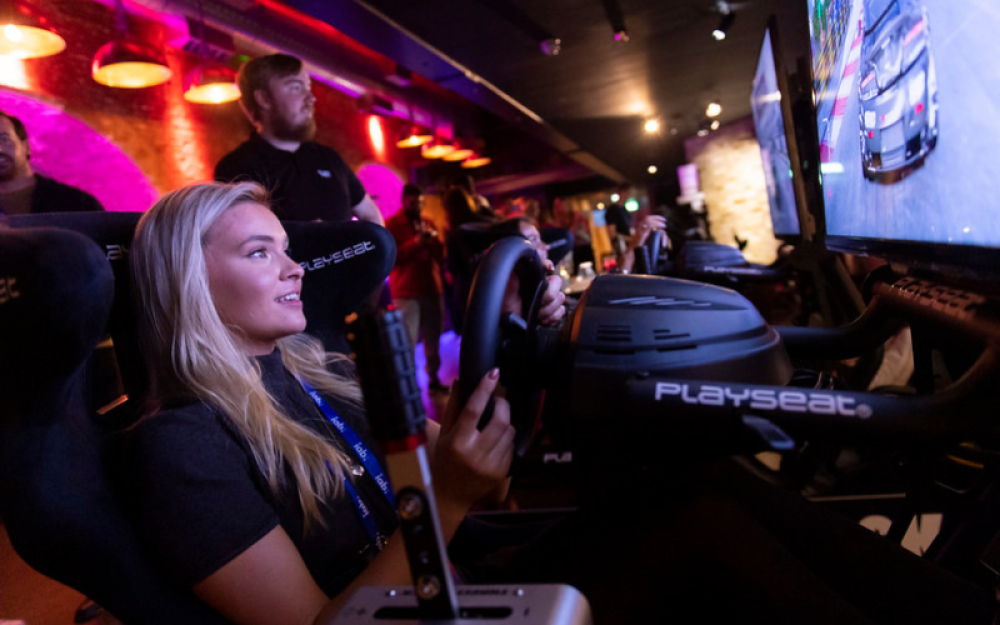 Jess playing car games at gaming upfronts 