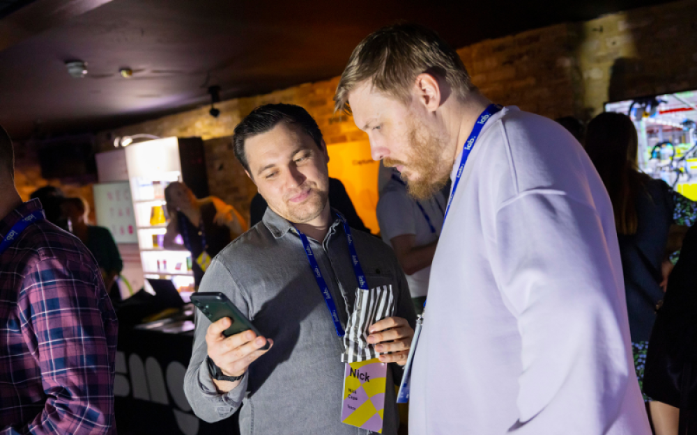 one member showing their phone to another member